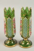 A FINE PAIR OF 19TH CENTURY GREEN BOHEMIAN GLASS VASES, with gilded decoration and panels of