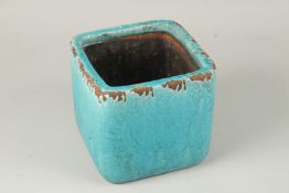 A TURQUOISE GLAZED SQUARE-FORM JARDINIERE, 18cm high.