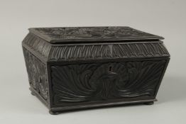 A FINE EARLY 19TH CENTURY CEYLONESE CARVED EBONY CASKET, with floral relief decoration, 27cm 18cm