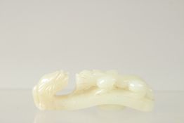 A FINE 19TH-20TH CENTURY QING DYNASTY CARVED WHITE JADE BELT HOOK, 6.5cm long.