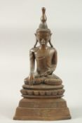 A BURMESE SEATED BRONZE BUDDHA, on a raised platform base, 38cm high, base 20cm wide.