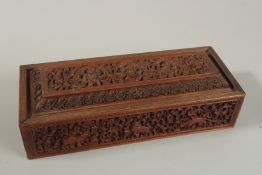 A FINELY CARVED 19TH CENTURY INDIAN MAYSORE SANDELWOOD BOX, 28cm x 11cm.
