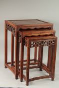 A CHINESE NEST OF THREE HARDWOOD TABLES, largest 59cm high, 43.5cm wide, 34.5cm deep.