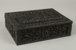 A FINE 19TH CENTURY ANGLO INDIAN MYSORE DEEPLY CARVED EBONY BOX, with finely carved animals and