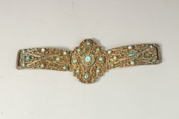 A 19TH CENTURY OTTOMAN TURQUOISE STONE INSET GILT SILVER FILIGREE DRESS ORNAMENT, 28cm long (open).