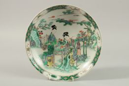 A CHINESE FAMILLE VERTE PORCELAIN DISH, painted with female figures surrounded by various objects in