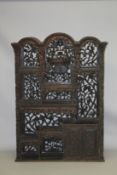 A CHINESE CARVED HARDWOOD OPENWORK CABINET, LATE 19TH CENTURY, with domed top, an arrangement of