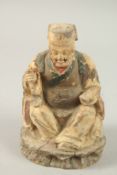 A CHINESE CARVED WOOD SEATED FIGURE, 18cm high.