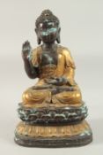 A CHINESE OR TIBETAN GILDED BRONZE SEATED BUDDHA ON A LOTUS BASE, 49cm high, base 29cm wide.