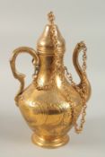 AN OTTOMAN TOMBAK ZAMZAM EWER / KEMZEMLIK, with engraved and chased foliate decoration, 36cm high.