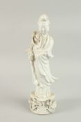 A BLANC-DE-CHINE PORCELAIN FIGURE OF GUANYIN STOOD UPON A LILYPAD, with fine floral details to the