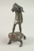 A CHINESE BRONZE FIGURE STANDING UPON A TOAD, 19cm high.