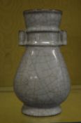 A Chinese celadon crackle glazed vase with loop handles.