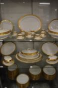 A comprehensive Lamoge gilt decorated dinner service.