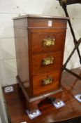 A pair of small mahogany three drawer pedestal chests.