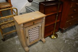Small pine cupboard bookcase and a lamp.