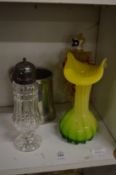 A tulip shaped glass vase and other items.