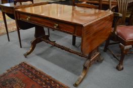 A good early 19th century mahogany sofa table with single frieze drawer on carved end supports