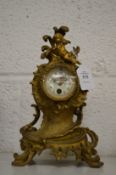 A small ormolu mantel clock.