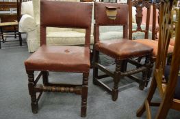 A pair of oak dining chairs.