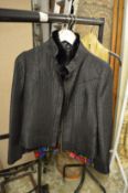 A ladies fur trimmed black quilted jacket.