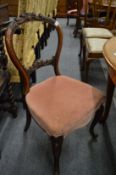 A set of four Victorian carved walnut dining chairs.