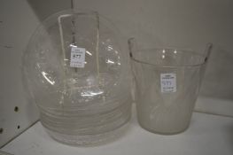 A collection of etched glass ice plates together with an ice bucket.