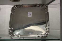 A silver square shaped salver.