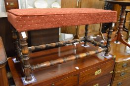 A long upholstered stool.