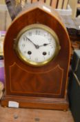 A mahogany mantel clock.