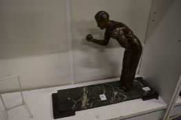 An Art Deco spelter and marble model of a bowls player.