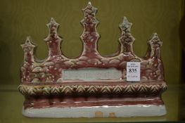 A Chinese red glazed pottery brush rest.