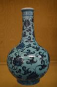 A Chinese turquoise ground bottle vase decorated with scrolling flowers and calligraphy to the