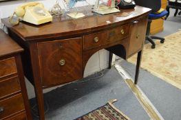 A mahogany bow front sideboard.