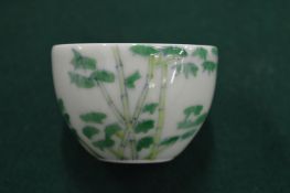 A small Chinese porcelain cup.