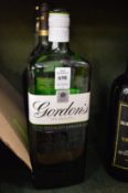 A 1 litre bottle of Gordons gin and two other items.