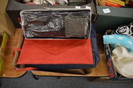 A pair of leather gloves and two handbags.