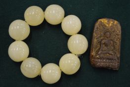 Chunky bead bracelet and a Eastern carving.