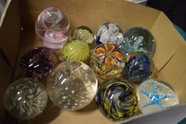 A collection of glass paperweights.