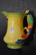 A Burleigh Ware jug with a parrot handle.
