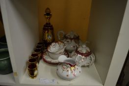 A tea for two service and gilt decorated ruby glass liqueur set.