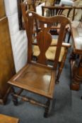 Two 18th century oak solid seat dining chairs.