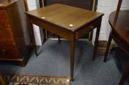 A mahogany occasional table with a drawer to each end on tapering legs.