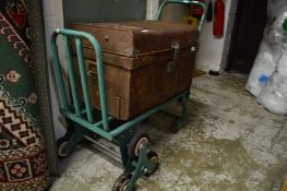 A folding stair walker sack trolley/truck together with a tin trunk.
