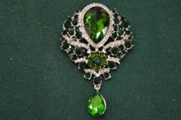 A large faux emerald pendant/brooch.