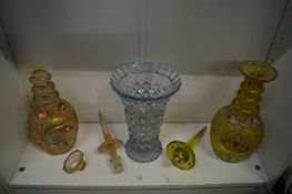 Two enamel decorated cut glass decanters (faults) together with a vase.