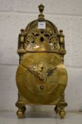 A reproduction brass lantern clock.