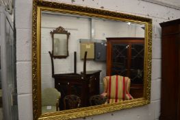 A large modern gilt framed mirror.