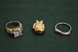 A gold boxing glove charm and other items.