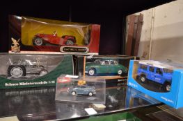 Five boxed model cars etc.